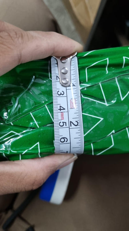 Ganesh Crystal LED Lamp - Shoppingstore25Shoppingstore258121759318A hand holds the Ganesh Crystal LED Lamp, a green patterned object wrapped in plastic, with a measuring tape showing its width is about 12 centimeters.