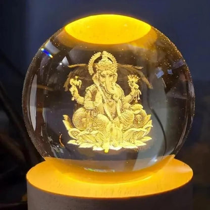 Ganesh Crystal LED Lamp - Shoppingstore25Shoppingstore258121759318The Ganesh Crystal LED Lamp features a crystal sphere on a glowing yellow base, showcasing a golden engraving of Lord Ganesha seated amid ornate patterns—a stunning centerpiece for any space.